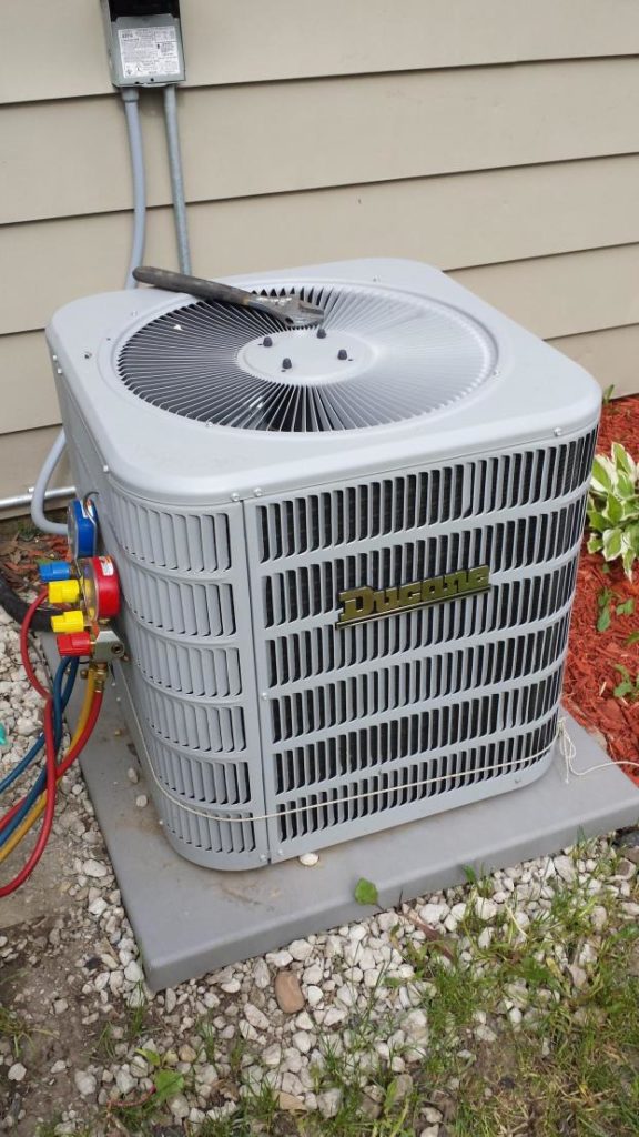 Ducane 13 SEER ac condenser unit outside an Aurora home needing air conditioning repair