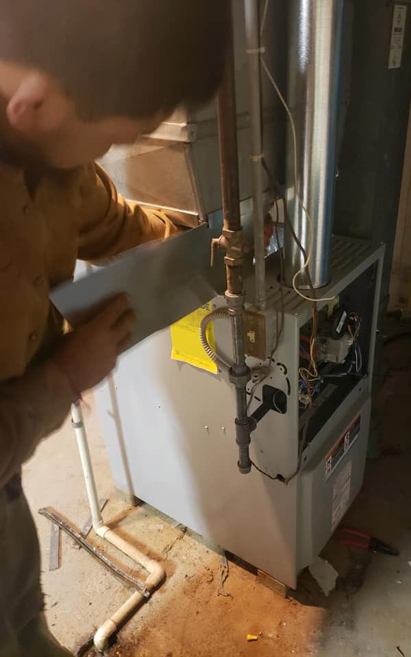 Maximum furnace repair and service technician doing work in Aurora basement